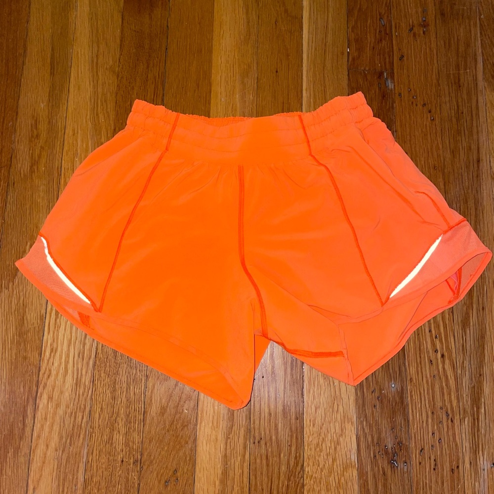 Highlight orange 4 inch lululemon shorts